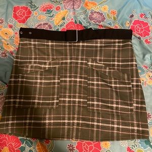 Size large olive green plaid with stripes of pink white and black.